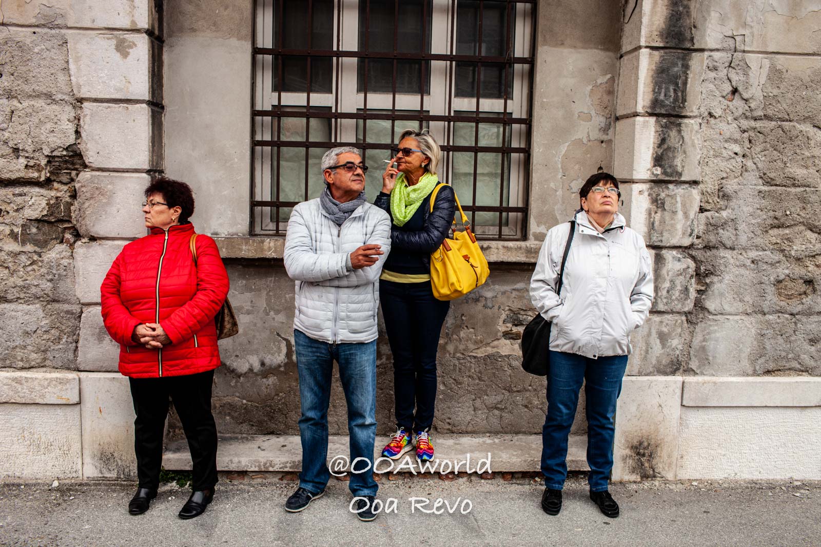 Trieste Italy group of people standing against a stone wall Photo OOAworld