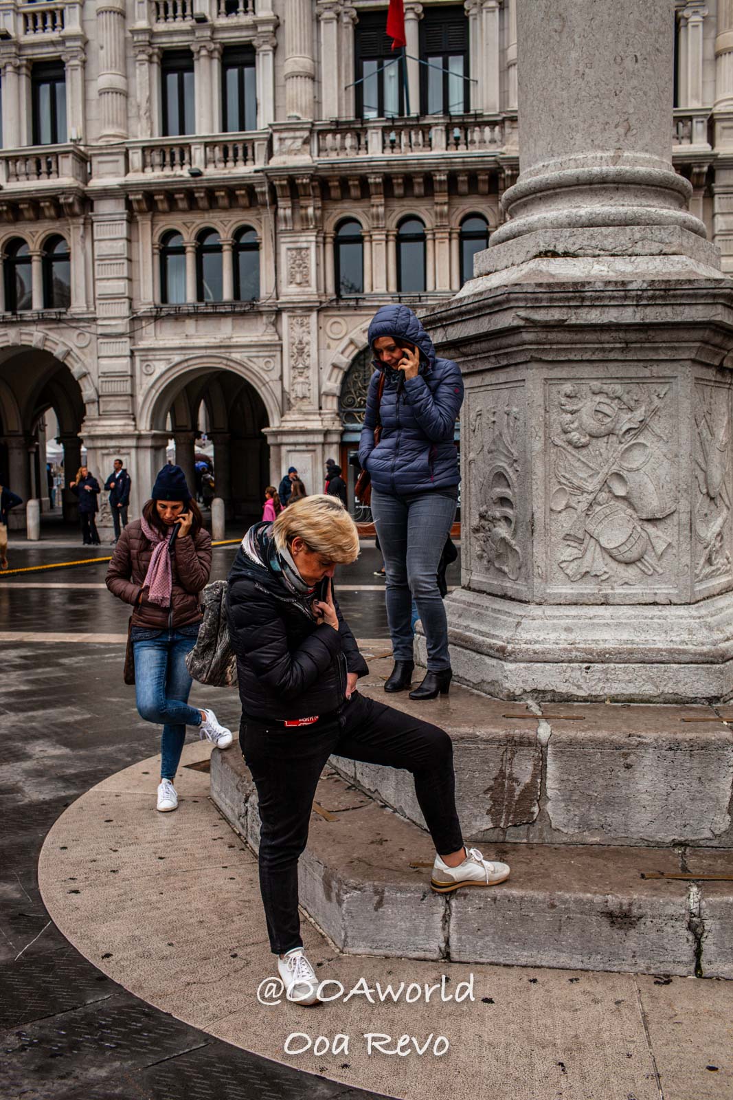 Trieste Italy people on phone near historic building Photo OOAworld