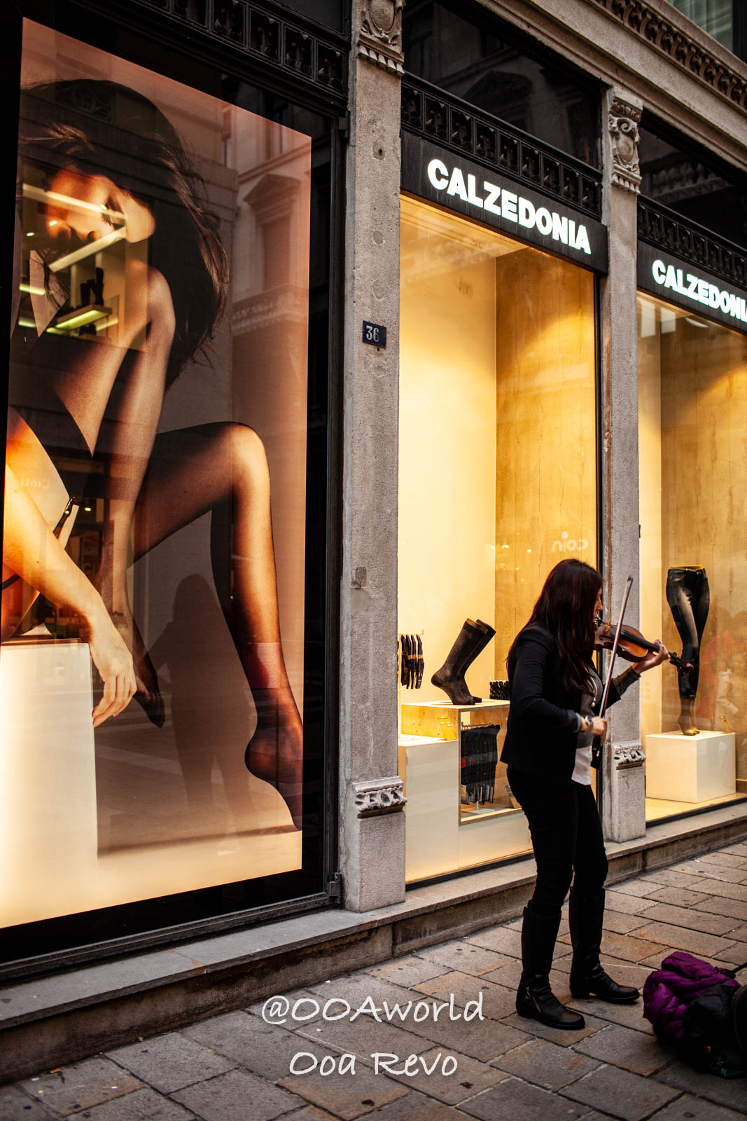 Trieste Italy street performer playing violin in front of Calzedonia store Photo OOAworld
