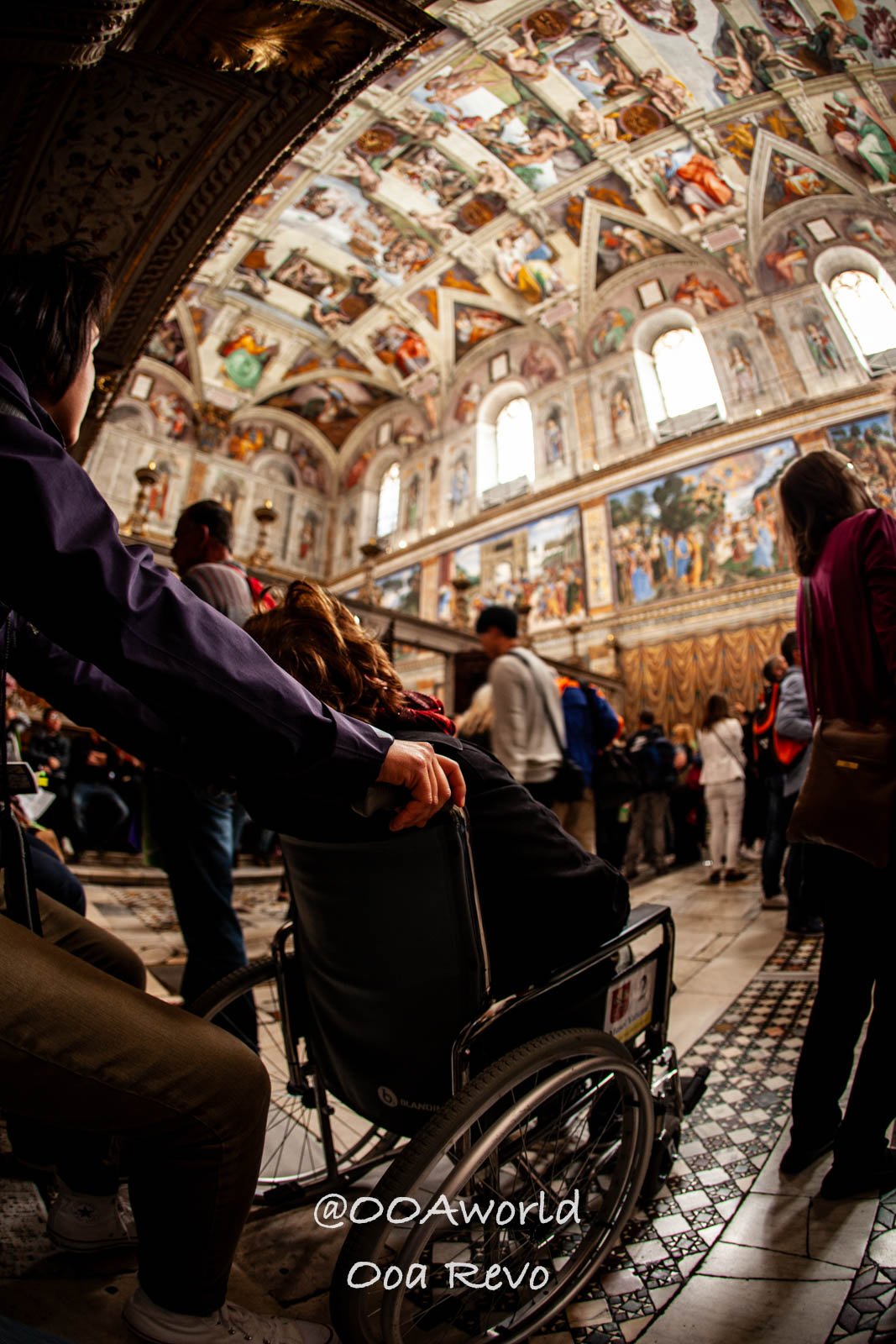 Vatican Italy Sistine Chapel wheelchair visitor vibrant frescoes Photo OOAworld