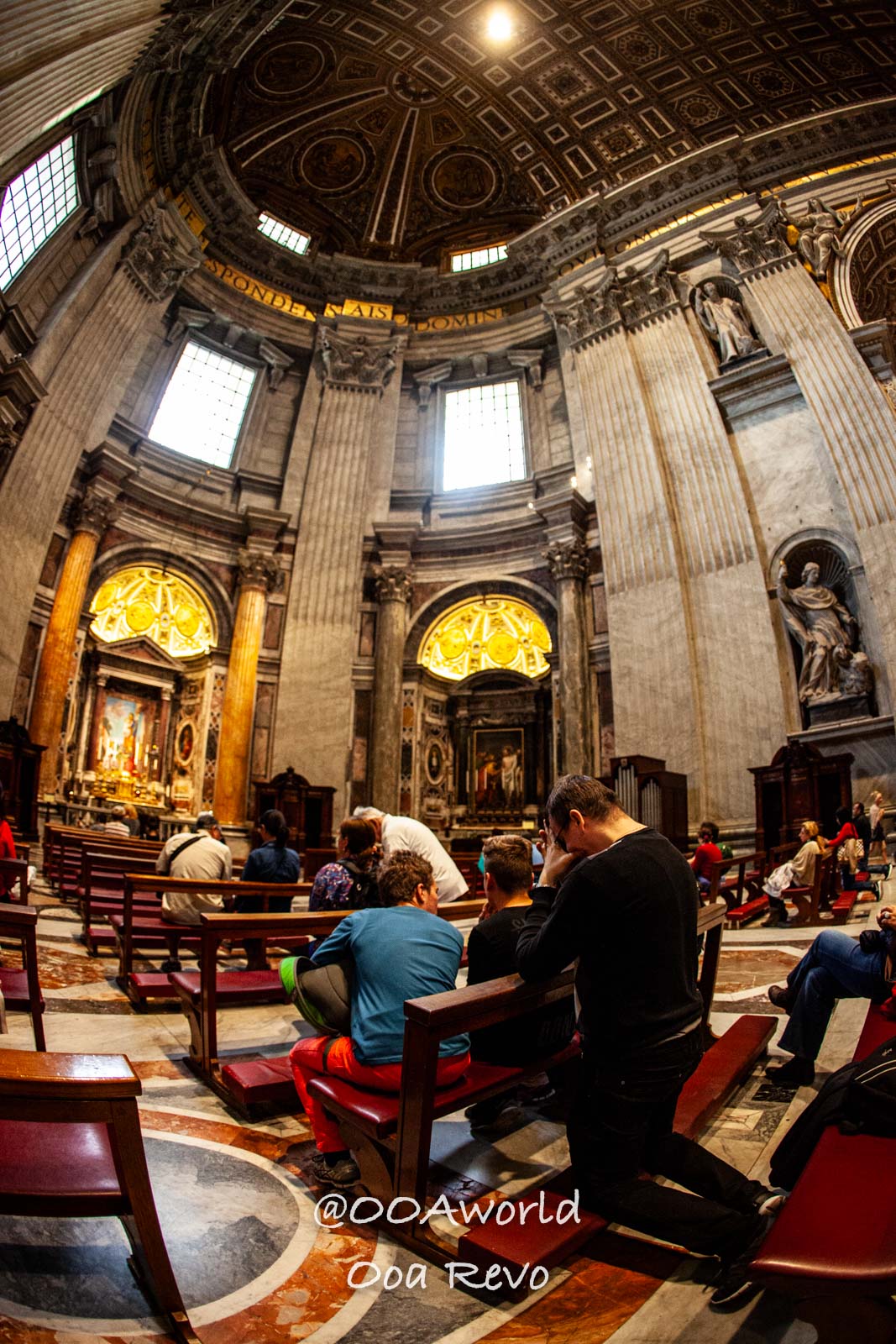 Vatican Italy interior of a grand cathedral with people seated and praying Photo OOAworld