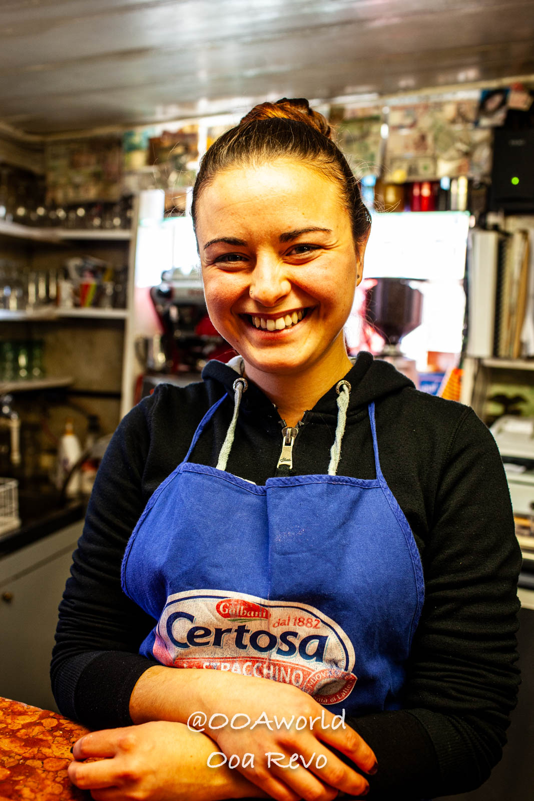 Venice Italy Smiling local woman in blue apron at cozy shop Photo OOAworld