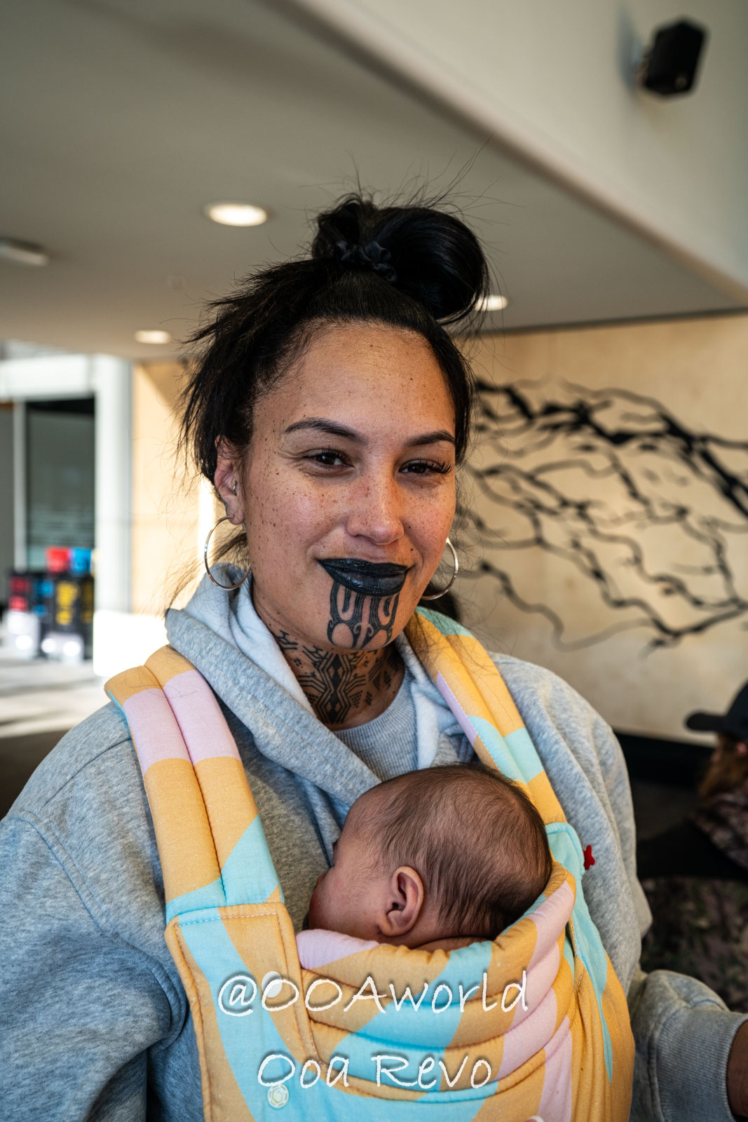 Wellington, Martinborough to Huka Falls New Zealand woman with traditional tattoo holding baby Photo OOAworld