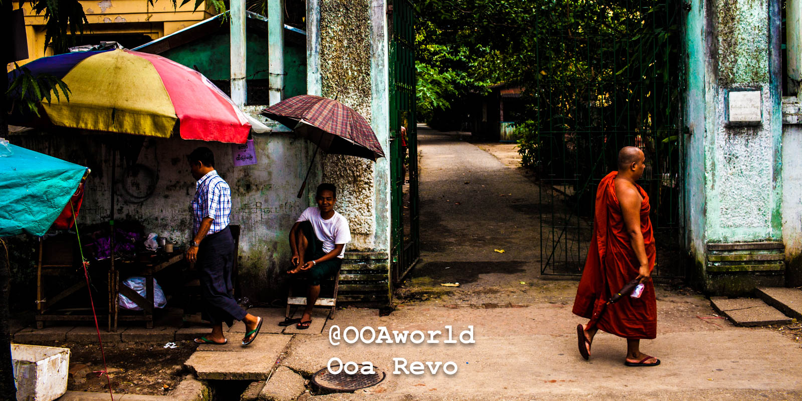 Yangon People and Streets Yangon Myanmar street scene with monk and colorful umbrellas Photo OOAworld