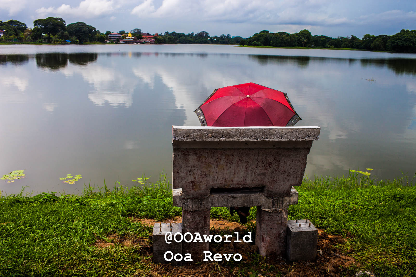 Yangon People and Streets Yangon red umbrella by lake serene landscape Photo OOAworld