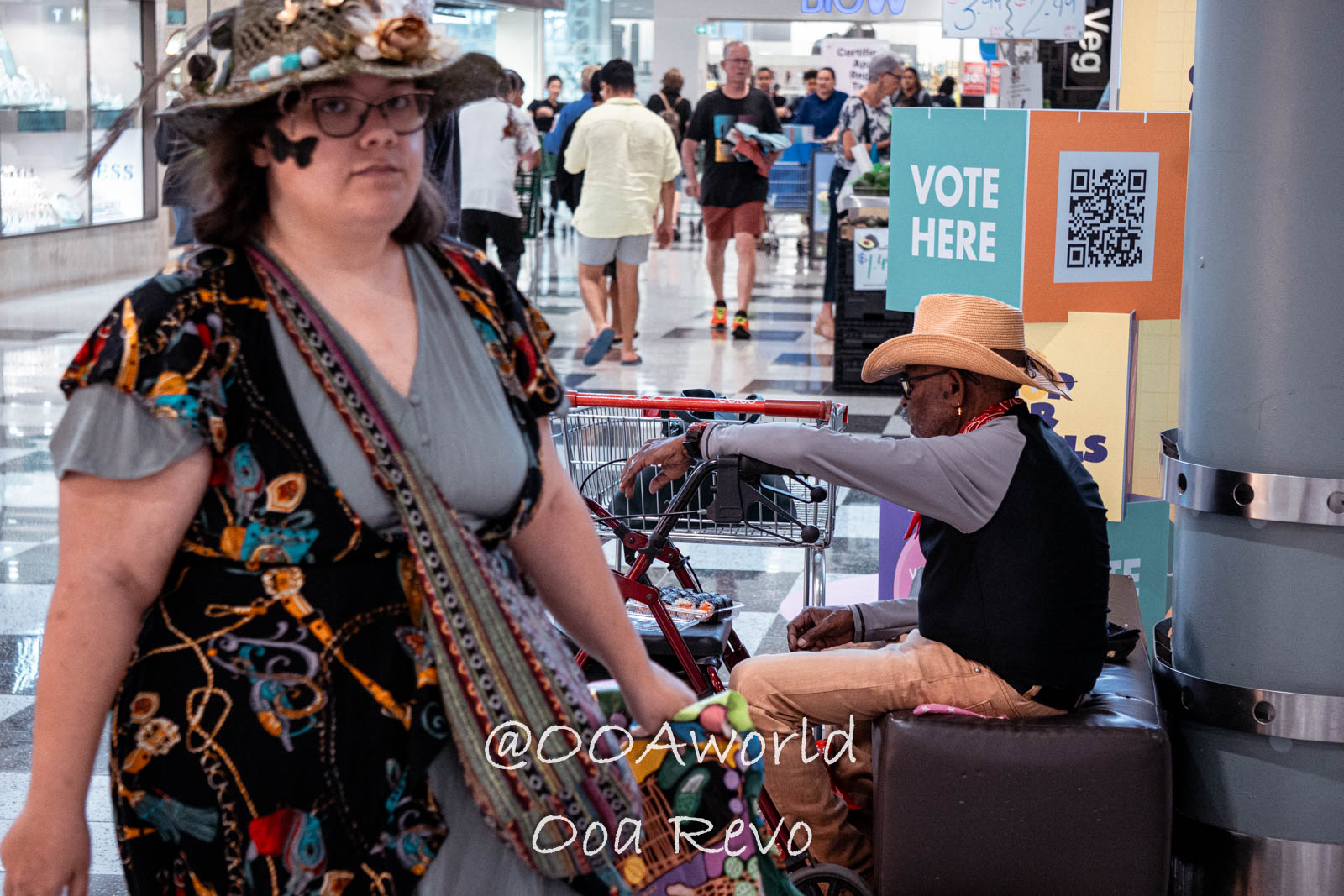 Cairns Australia people in busy shopping center with vote sign Photo OOAworld