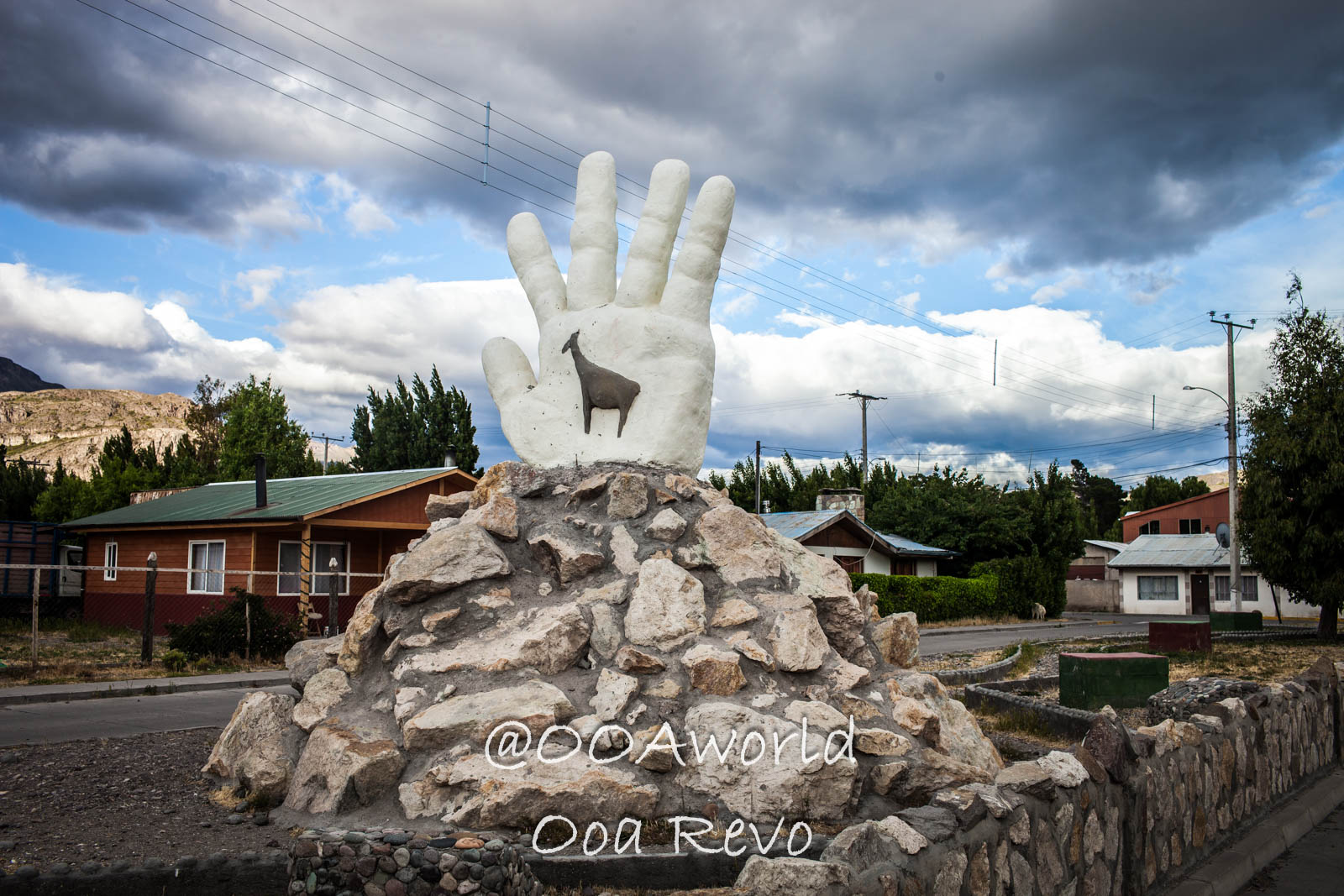 Chile Chico People Streets Chile Chico hand sculpture and llama engraving under cloudy sky in Patagonian town Photo OOAworld