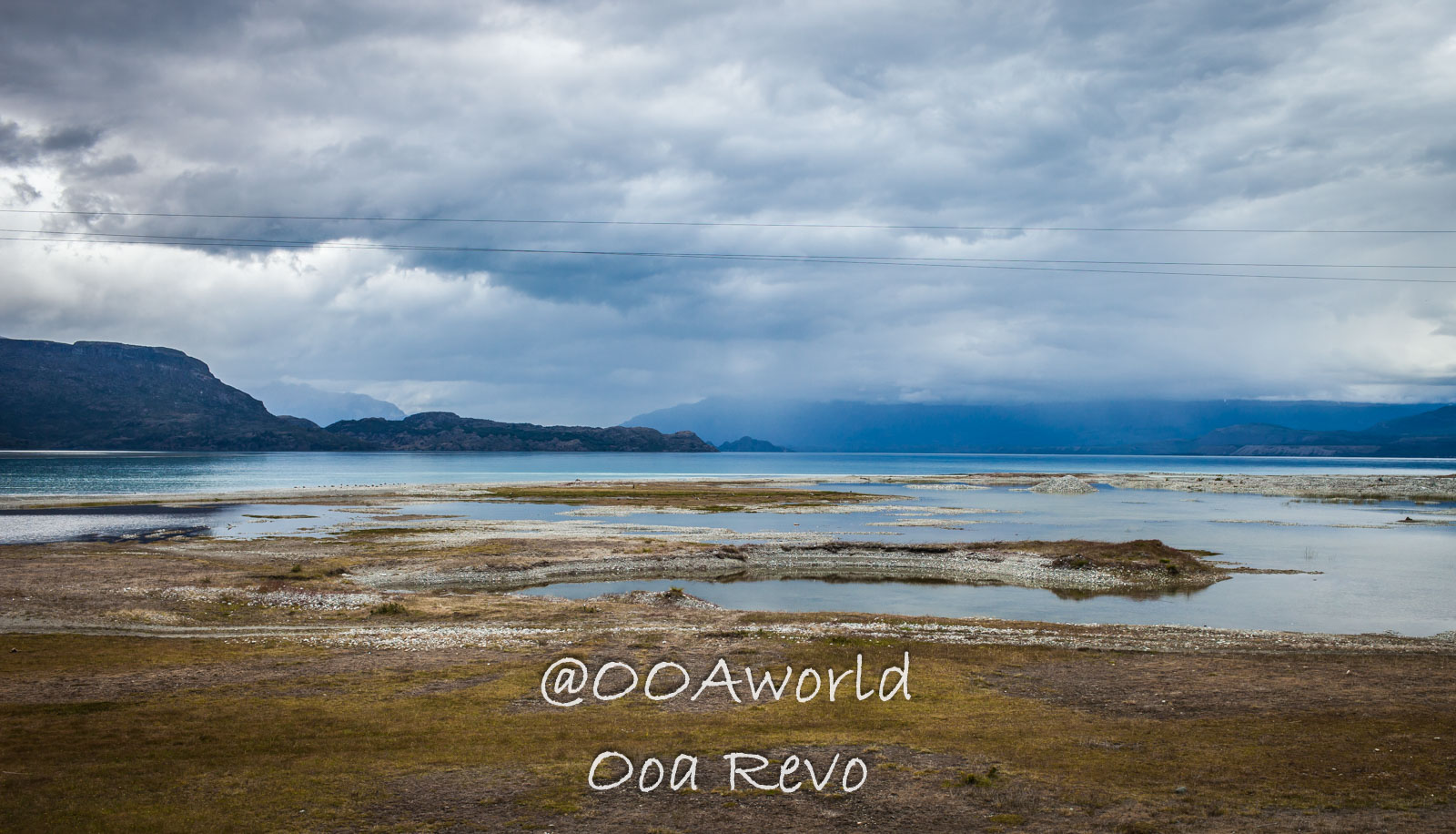Bus Chile Chico to Puerto Rio Tranquilo Landscapes Chile Chico dramatic lake landscape under cloudy skies Photo OOAworld