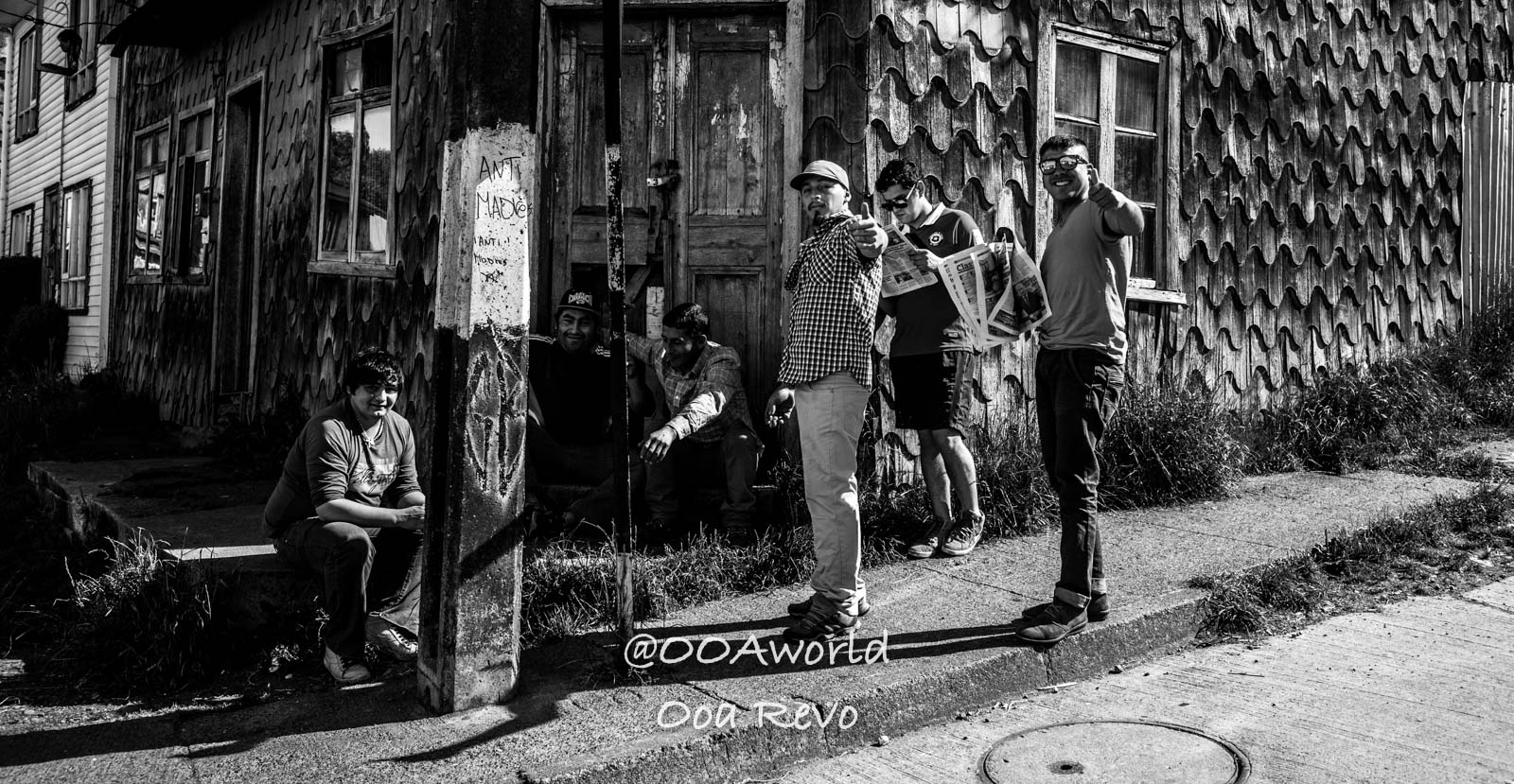 Palafitos and NYE Chiloe group of people outside wooden building black and white Photo OOAworld