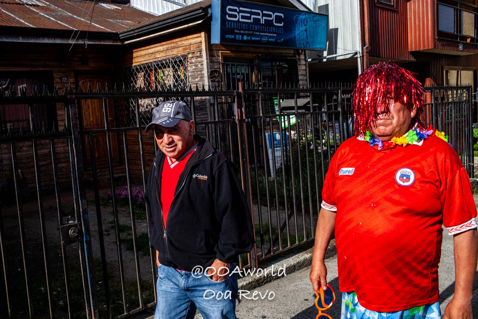 Palafitos and NYE Chiloe men in colorful costumes on street Photo OOAworld