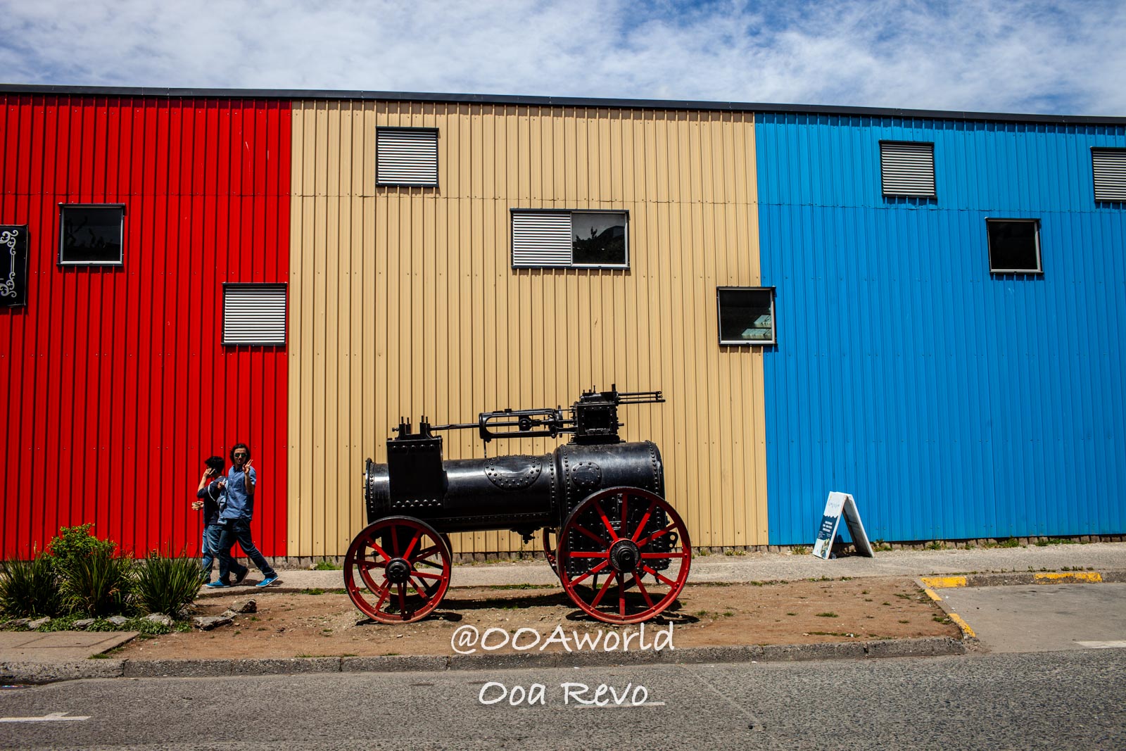 Palafitos and NYE Chiloe historic steam engine in front of colorful building Photo OOAworld