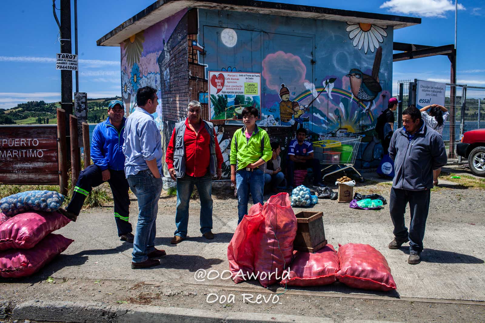 Castro Street Photography Chiloe local market scene with people and vibrant mural Photo OOAworld