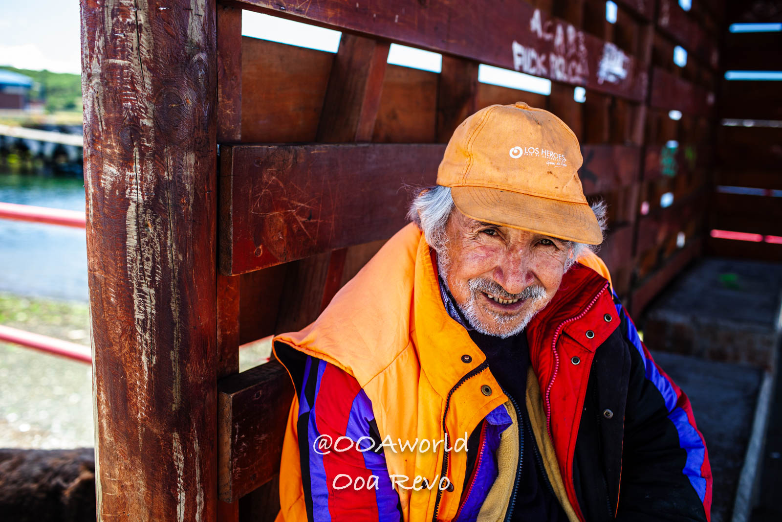 Castro Street Photography Chiloe elderly man in colorful jacket and cap smiling Photo OOAworld