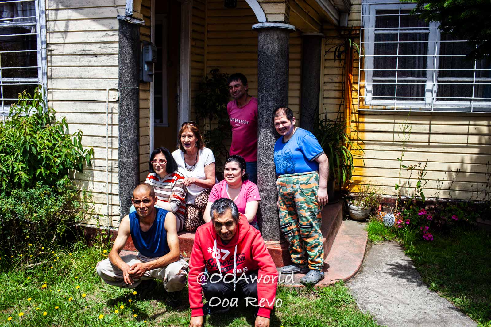 Castro Street Photography Chiloe group photo smiling people porch garden Photo OOAworld