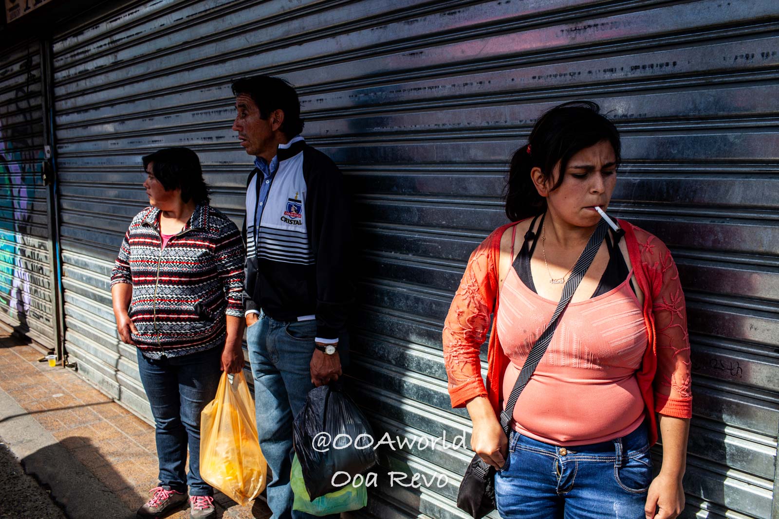 Castro Street Photography Chiloe People waiting in front of a shop with metallic shutter Photo OOAworld