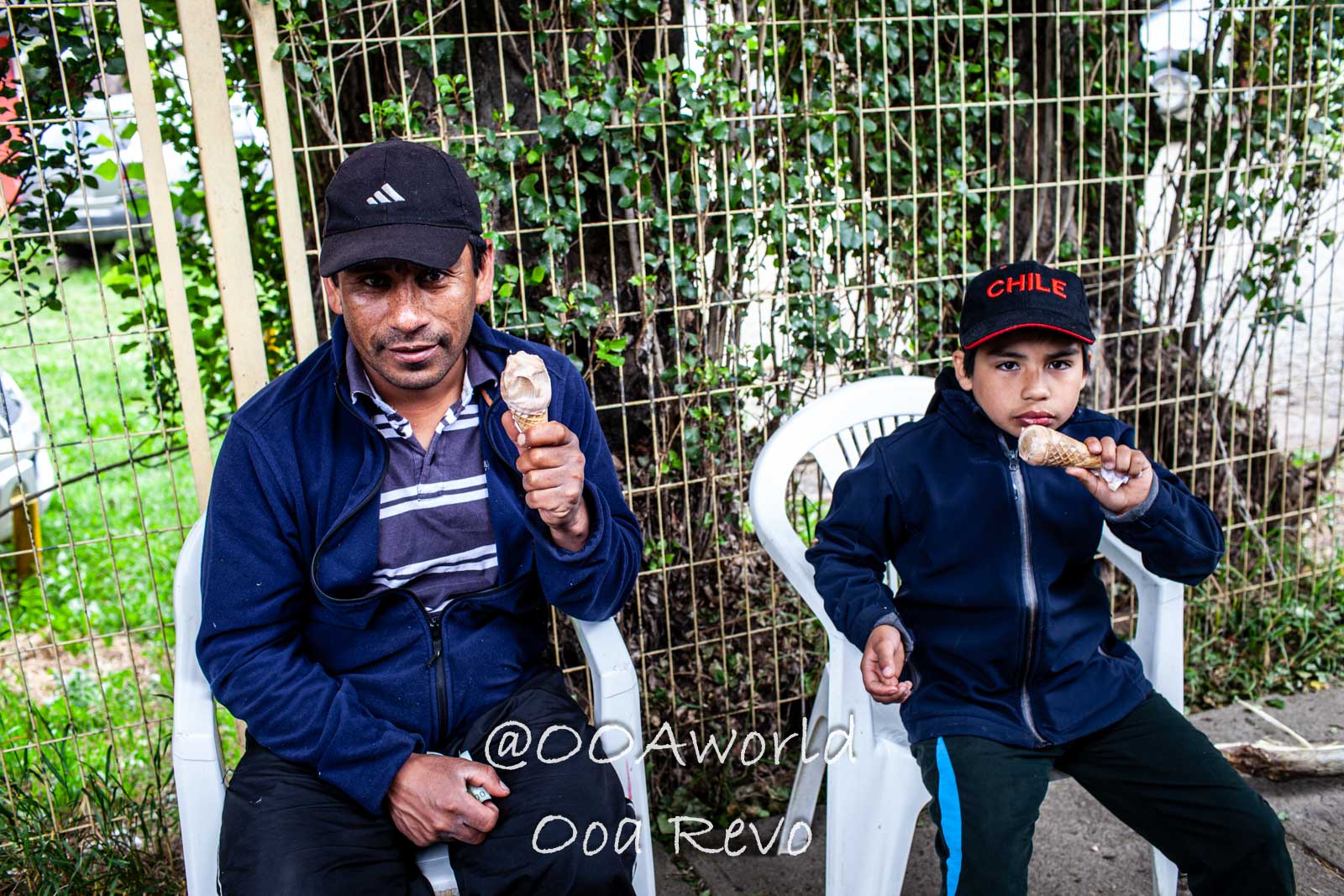 People and Streets Coyhaique Father and child eating ice cream outdoors Photo OOAworld