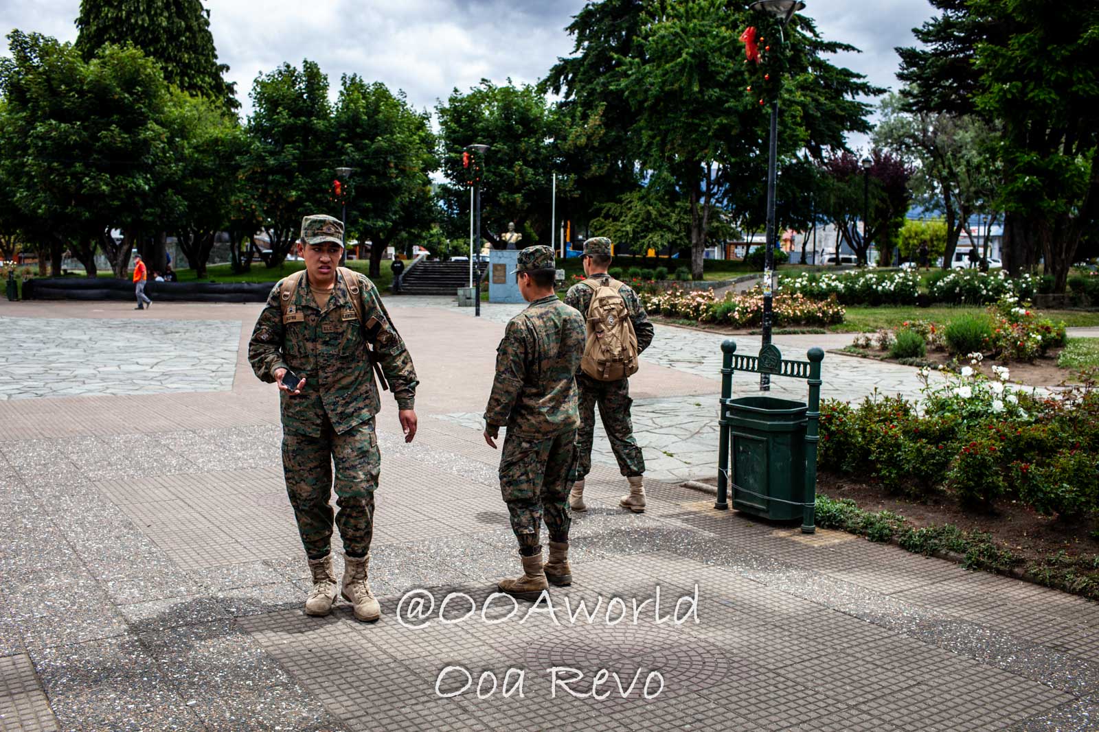 People and Streets Coyhaique military personnel walking in park with trees and path Photo OOAworld