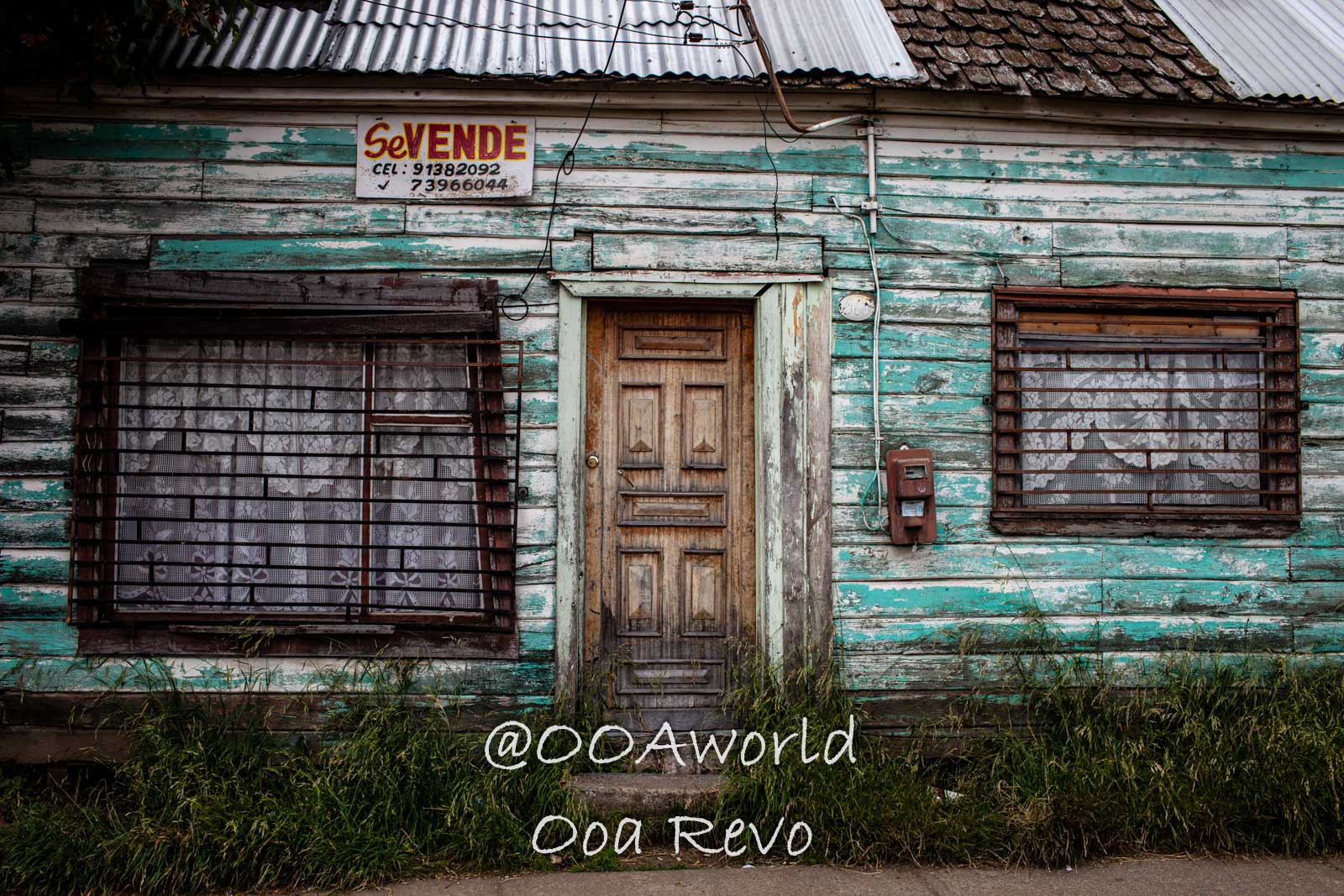 People and Streets Coyhaique old wooden house with for sale sign Photo OOAworld