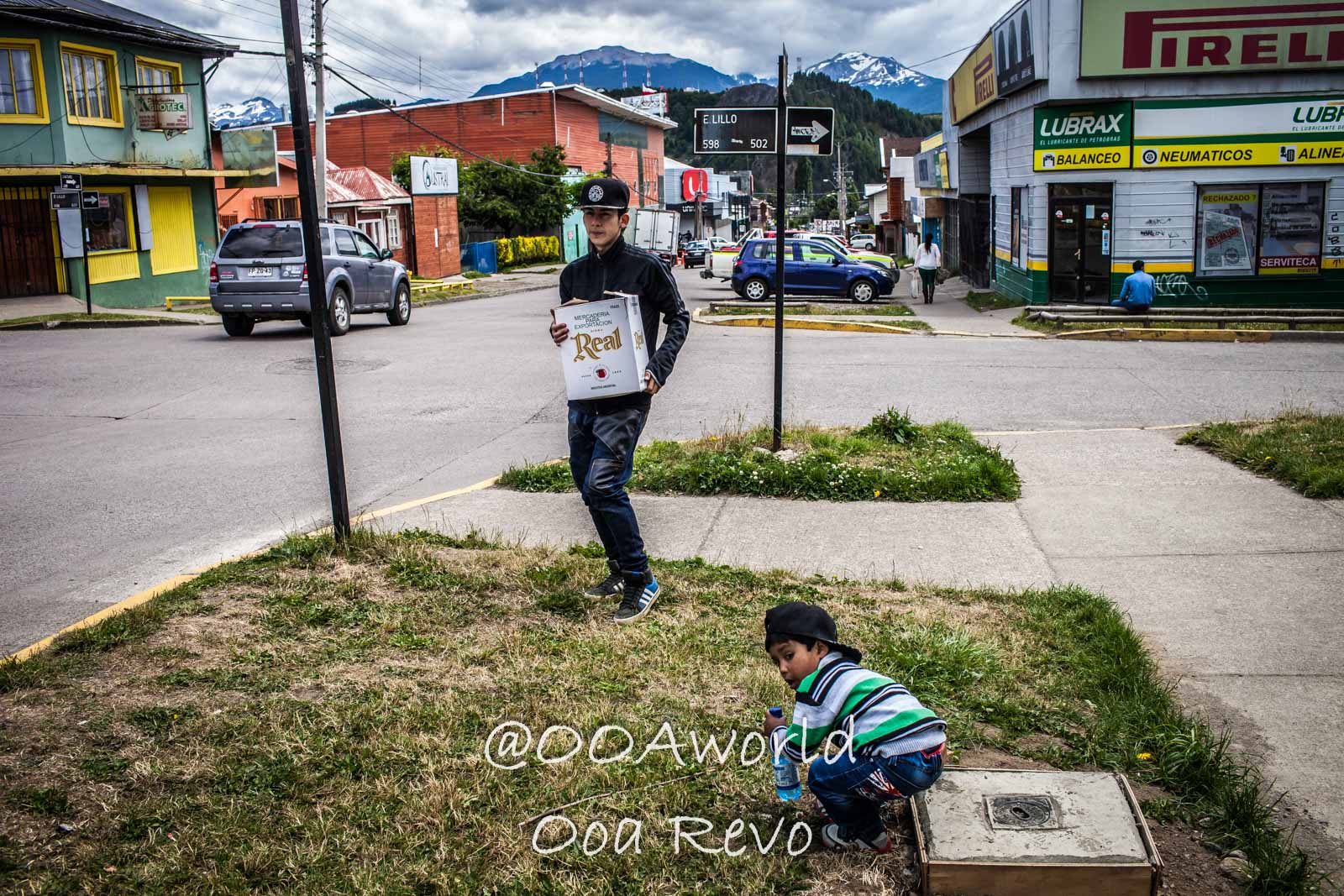 People and Streets Coyhaique Urban street scene with children mountain background Photo OOAworld