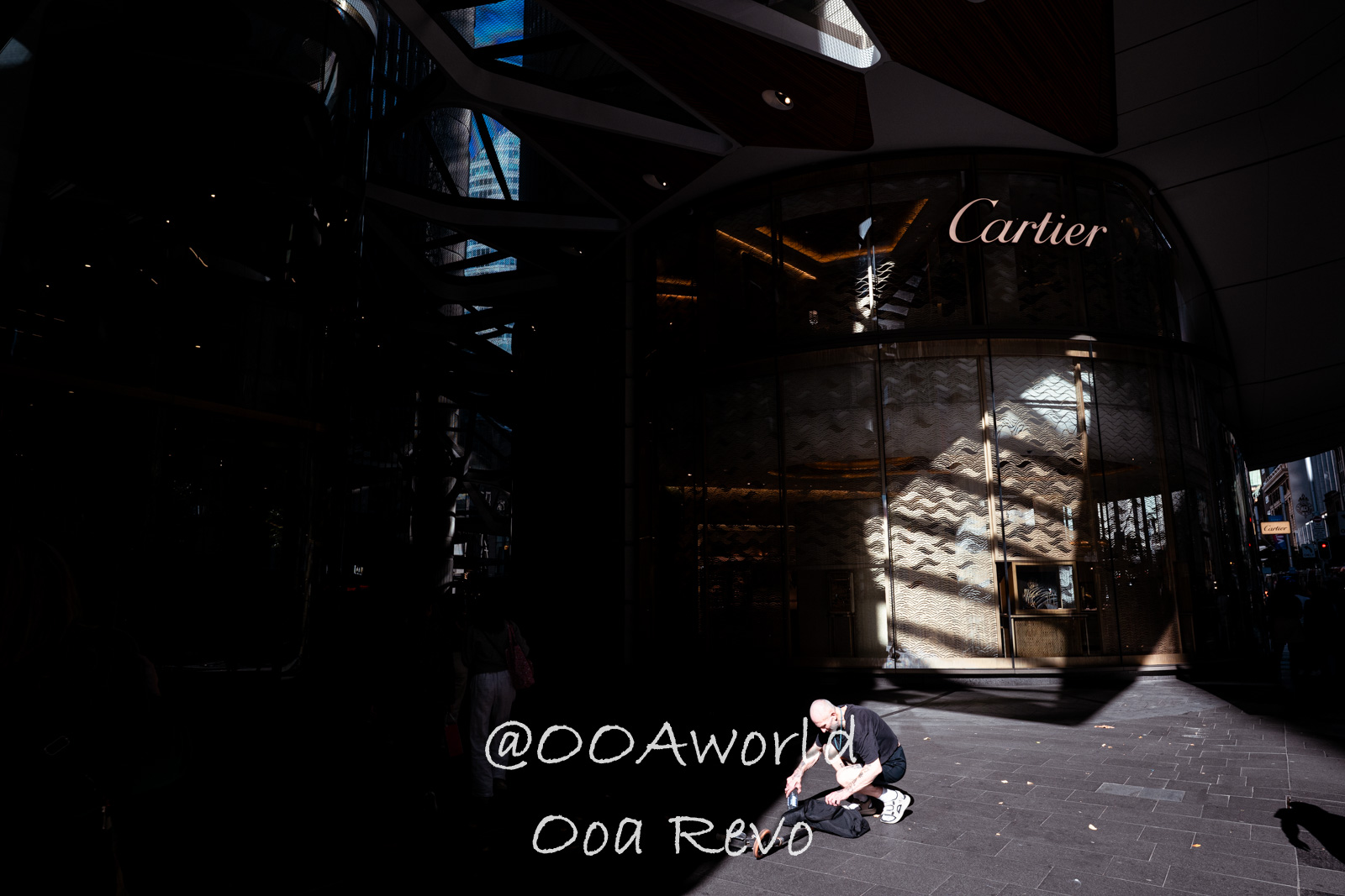 New Sydney Sydney urban street scene man crouching sunlit reflection Photo OOAworld