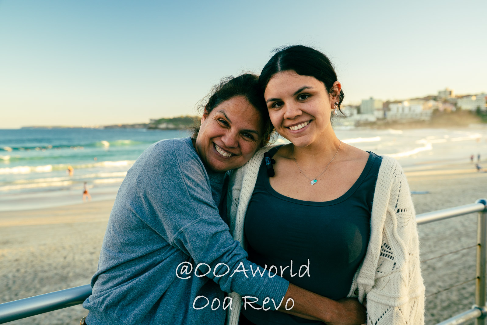 New Sydney Sydney Smiling friends embracing by seaside during sunset Photo OOAworld