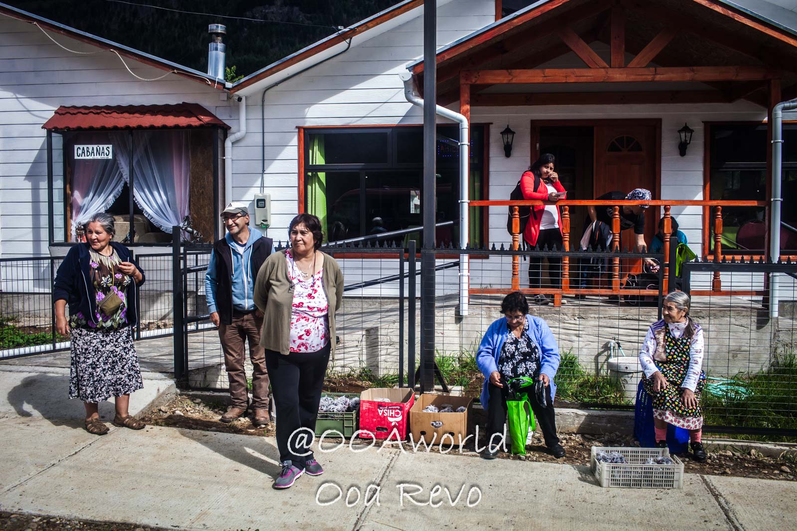 People Portraits Streets Puerto Cisnes local community gathering outside small business in rural village Photo OOAworld