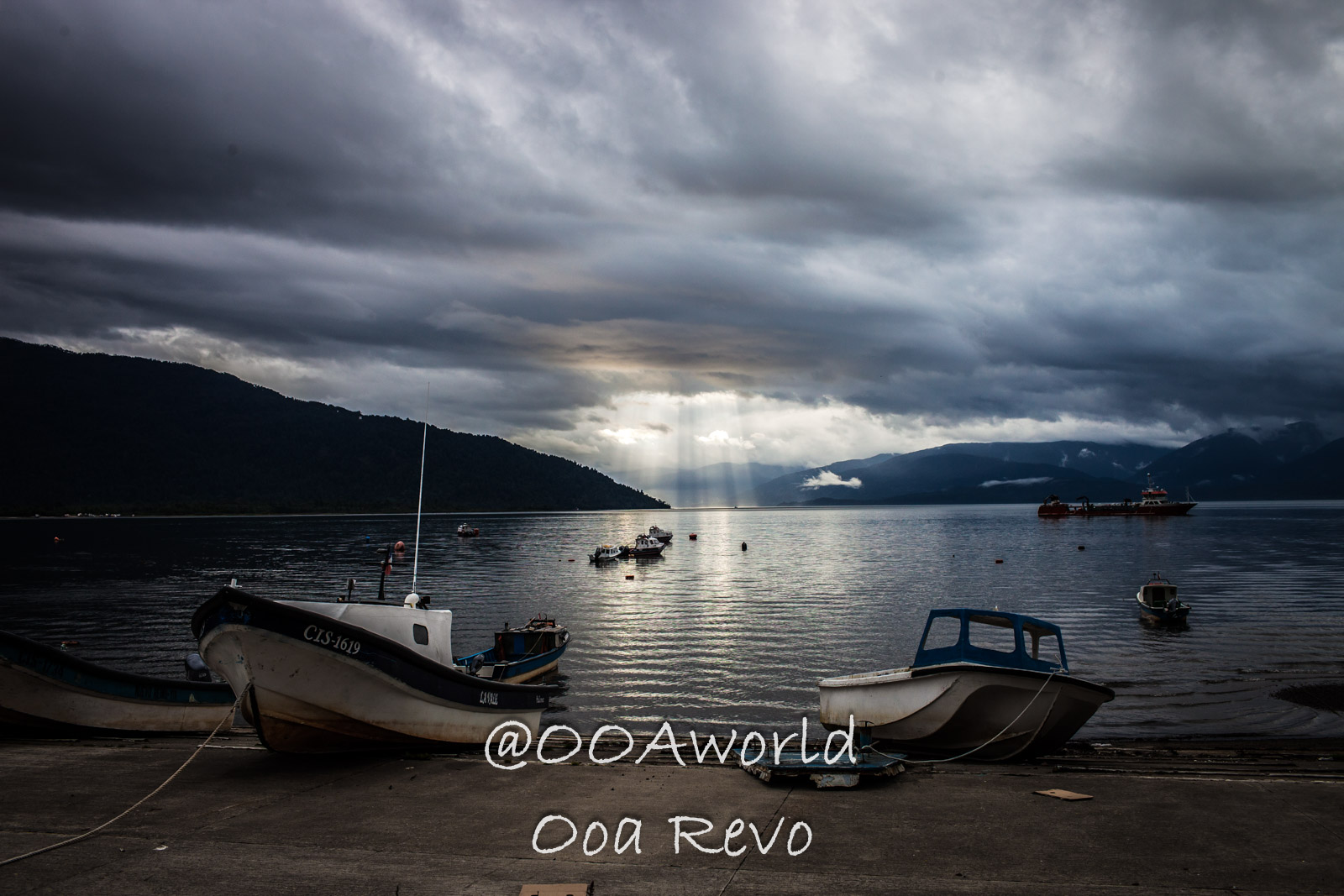 People Portraits Streets Puerto Cisnes boats on lake with dramatic clouds and sun rays Photo OOAworld