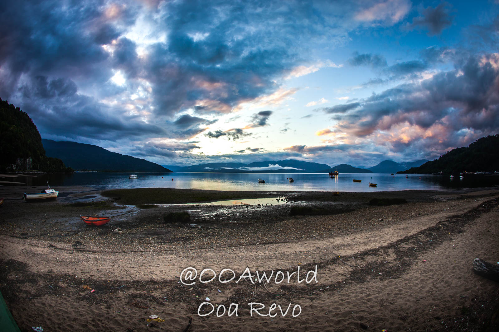 People Portraits Streets Puerto Cisnes dramatic sunset over tranquil lake with clouds and mountains Photo OOAworld